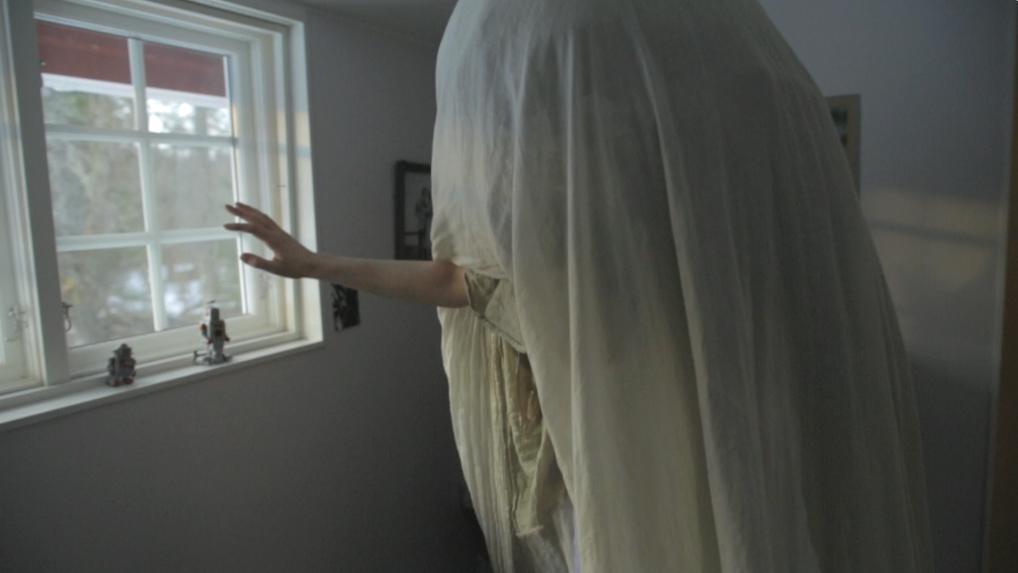 Still from Electric Malady. William walks around with a sheet draped over his head.