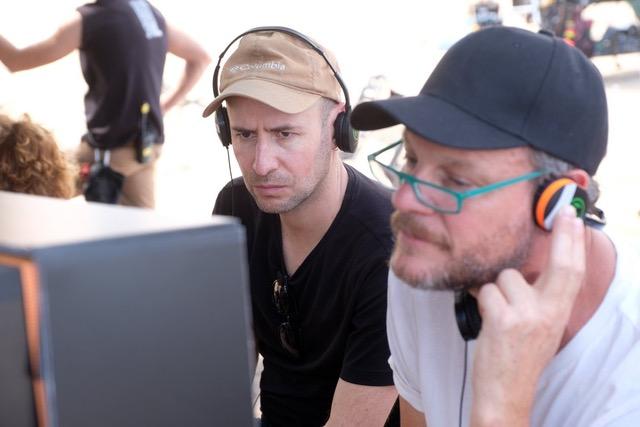 Two men in front of a monitor
