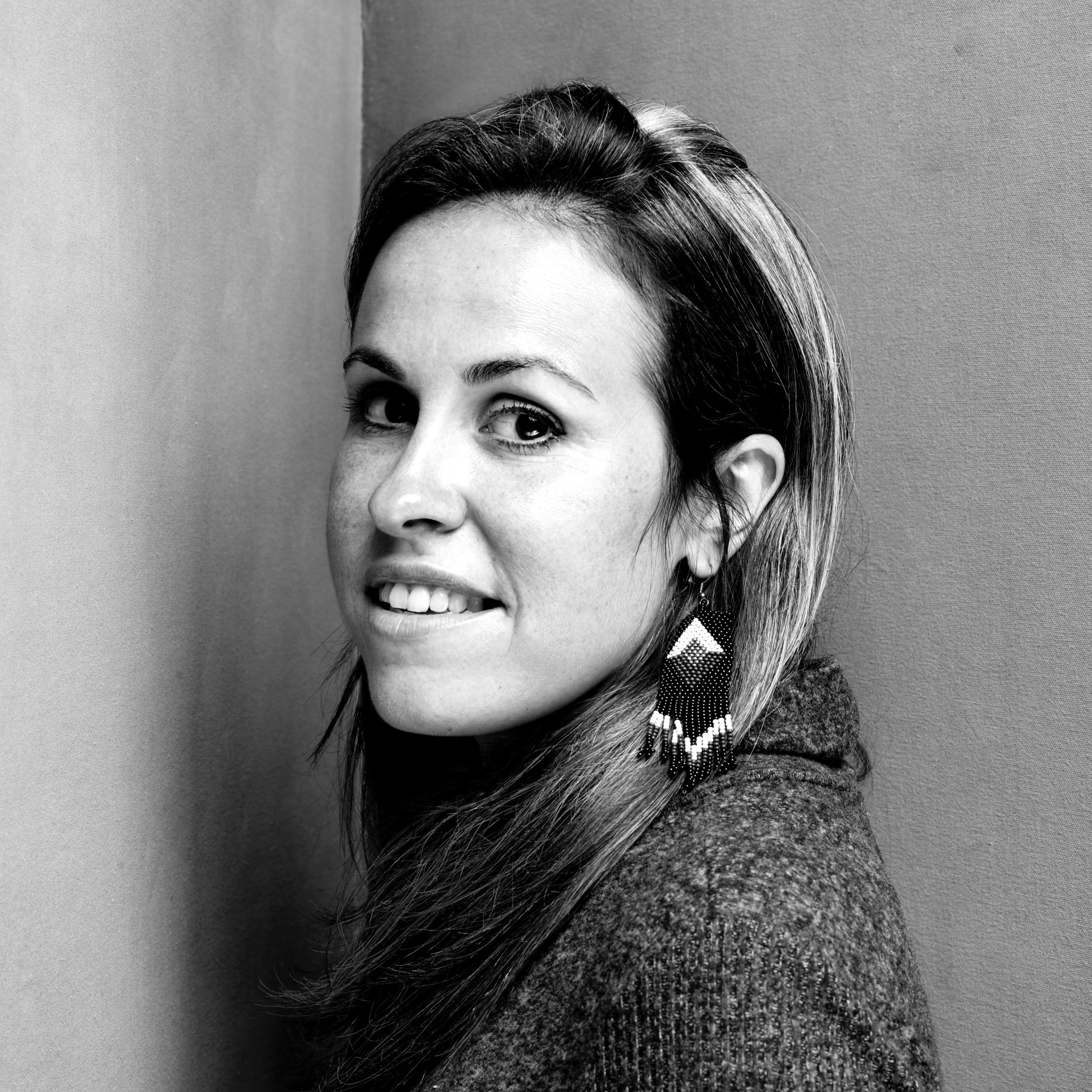 Jessica Earnshaw looking directly at the camera. Black and white portrait.