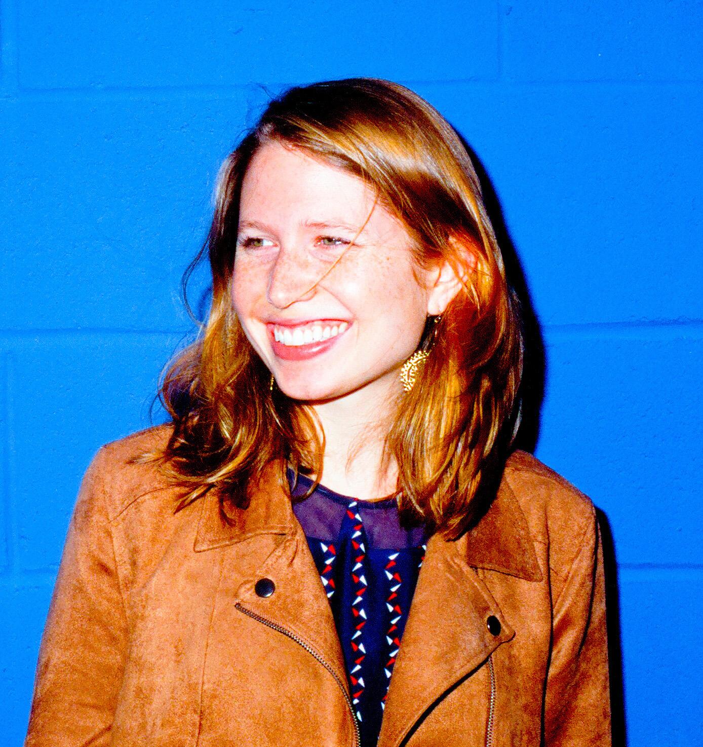 Holly Meehl Chapman looking to the right side of the camera. She is wearing earrings and has shoulder length hair.