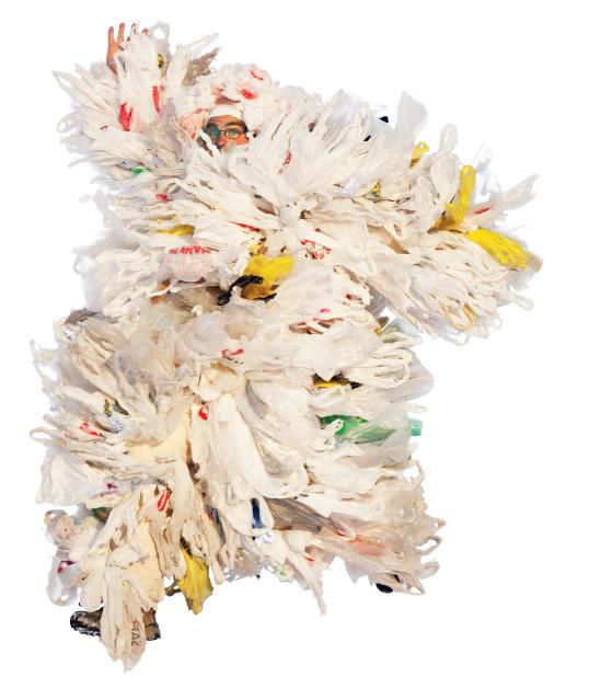 A sculpture made up of plastic bags with a man peeking his face out of it.