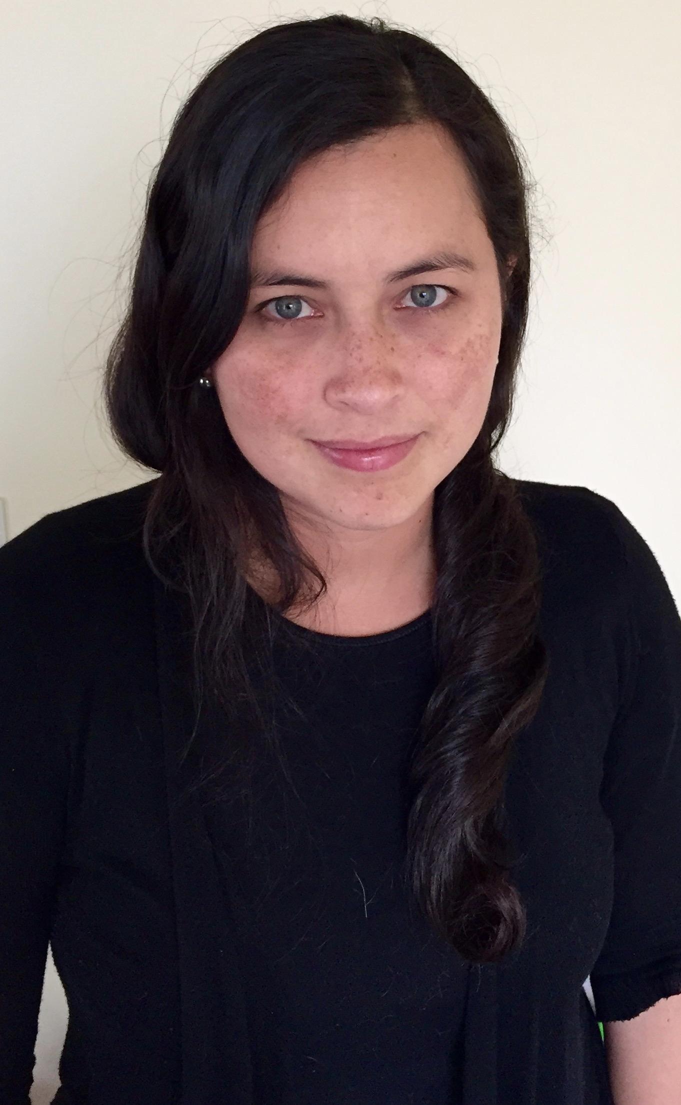 Viviana Gómez Echeverry looking at the camera. She has dark hair and freckles.