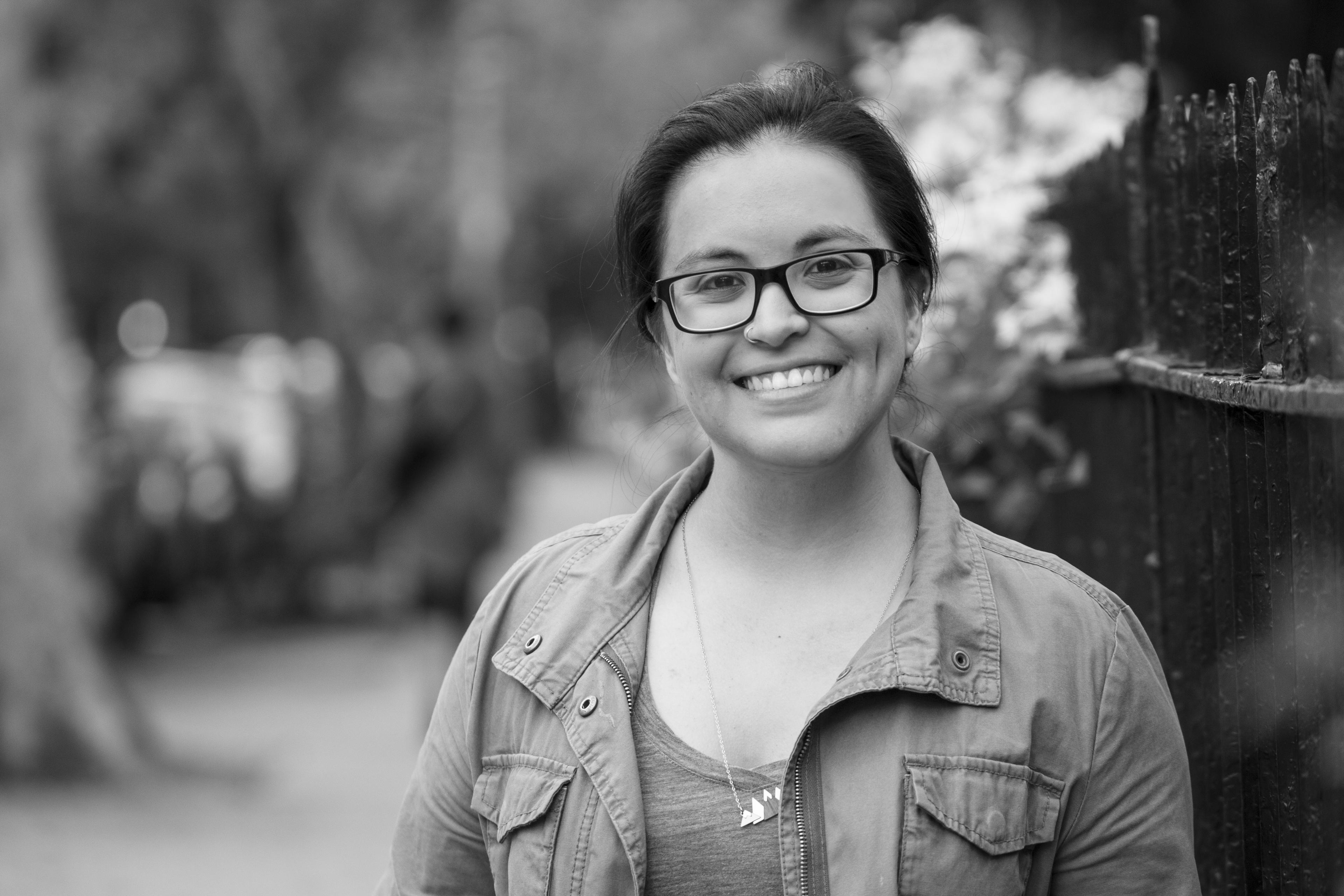 Isabel Alcántara looks directly at the camera and smiles. Portrait in black and white.