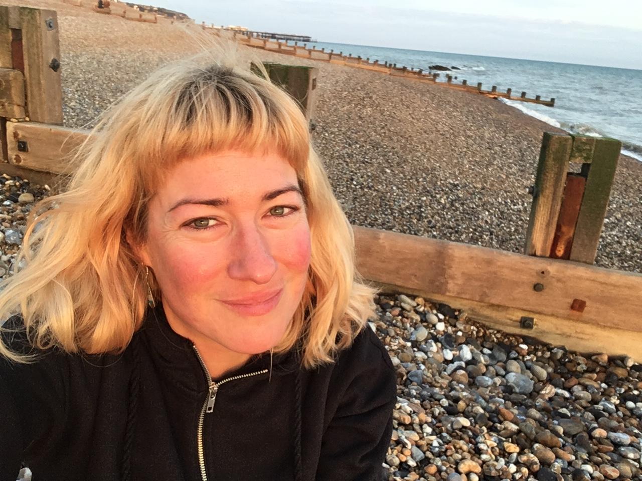 Portrait of Jasiewicz, a photo in a high angle, she has short length hair with fringes, and smiles at the camera.
